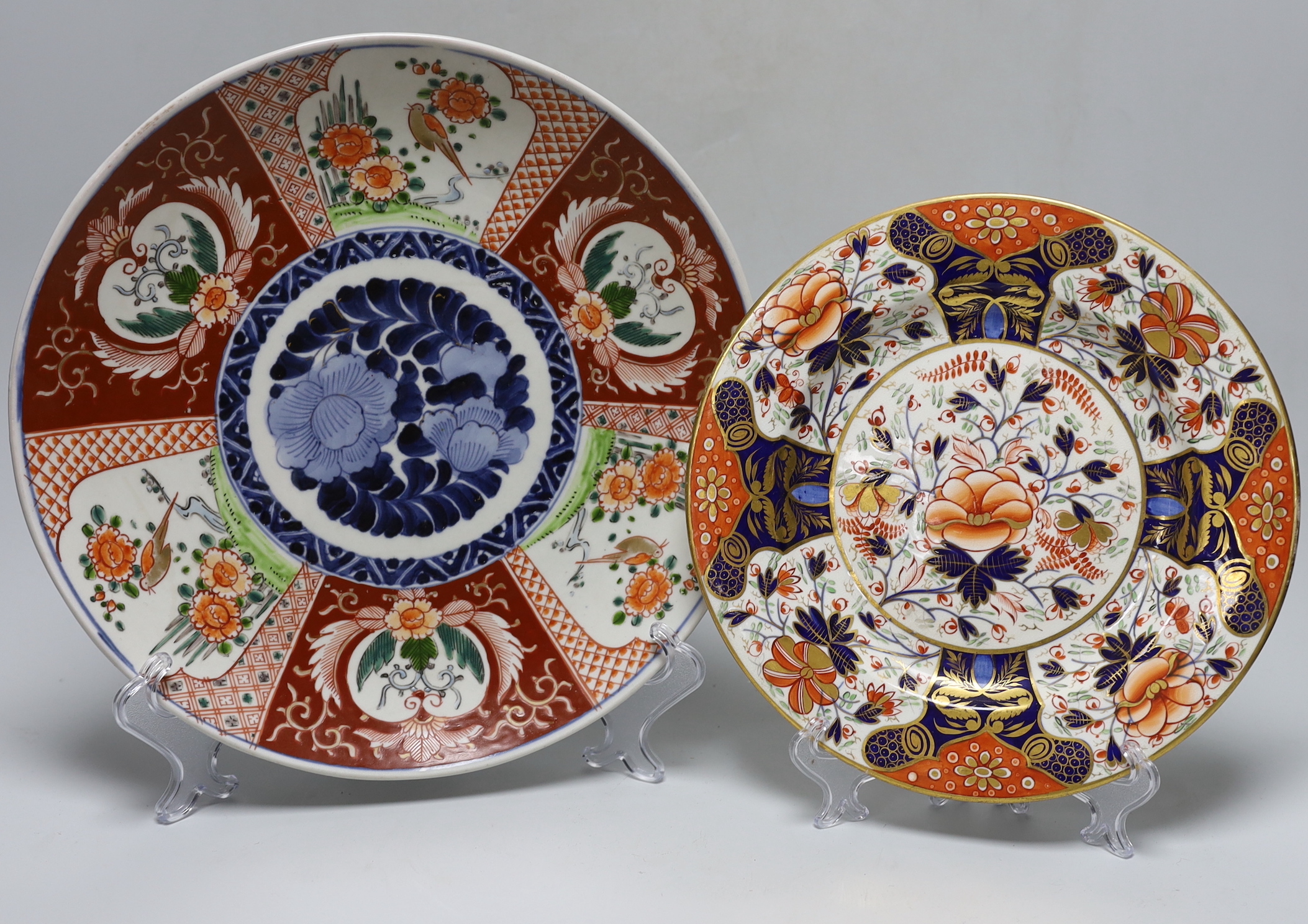 A Dresden pink ground jar and cover with gilt and floral decoration, 23cm tall, an Imari charger and a Royal Crown Derby plate